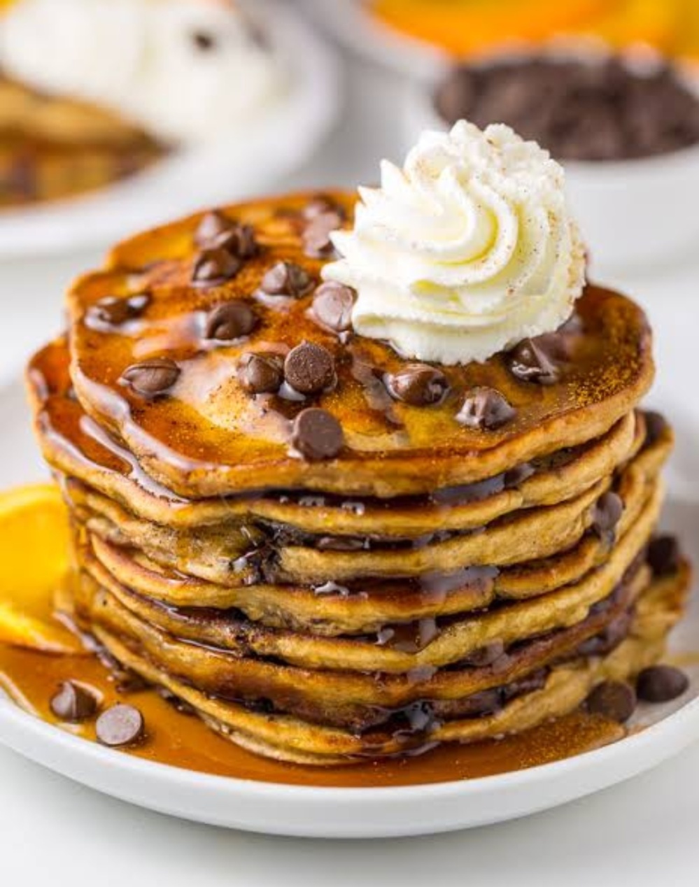 Chocolate chip pancakes with chocolate syrup and maple syrup